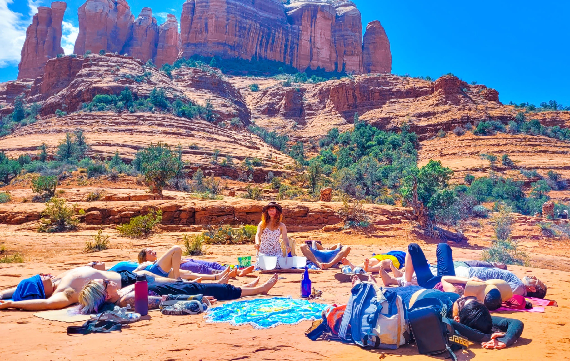A sound healing circle held beneath the red rock formations of Sedona